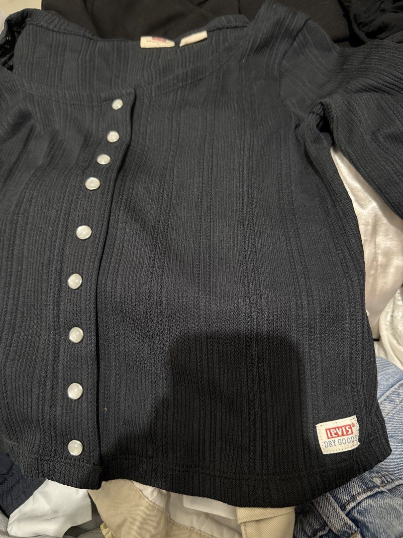 Levi's Black Ribbed Button-Up Long Sleeve Top (Category: Longsleeves) located in Manila. Submitted by hiiipurple (Listing ID 1459793408, Image 2). Description: - Brand: Levi's - Color: Black - Style: Long-sleeve top - Texture: Ribbed all over - Features: Pearl-like buttons down the front, square neckline - Detail: Small Levi's Dry Goods tag on the hem.