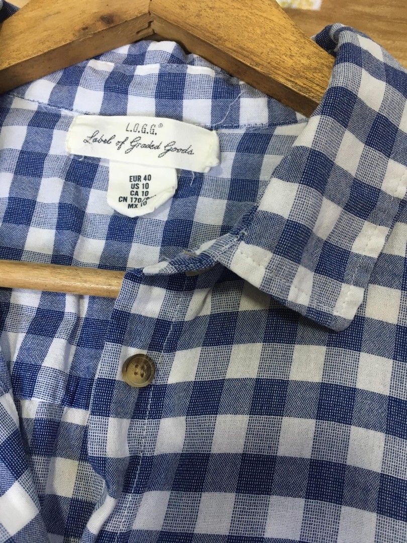 L.O.G.G. Blue Gingham Button-Up Shirt (Category: Blouses) located in Davao. Submitted by parenasnic86577 (Listing ID 1459723814, Image 2). Description: - Blue and white gingham pattern - Short sleeves - Collared neckline - Button-up front - Chest pocket - Brand: L.O.G.G. - Comfortable and casual style - Perfect for everyday wear.