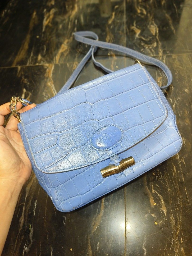 Longchamp Blue Croc Embossed Leather Shoulder Bag (Category: Luxury Bags & Wallets) located in Davao. Submitted by myrvelynjo32302 (Listing ID 1459825234, Image 1). Description: - Blue leather shoulder bag with luxurious croc embossing - Elegant gold hardware details - Adjustable strap for comfortable wear - Classic Longchamp toggle closure - Spacious interior, perfect for everyday essentials or evening outings.