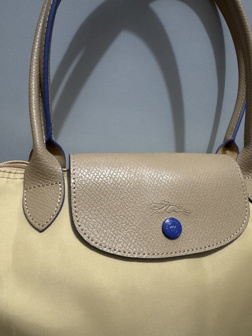Longchamp Le Pliage Tote Bag Beige (Category: Luxury Bags & Wallets) located in Subic. Submitted by dear.jeveaph (Listing ID 1459782427, Image 3). Description: - Classic Longchamp tote bag - Color: Beige nylon with tan leather trim and handles - Iconic horse logo detail - Closure: Zipper with snap button flap - Perfect for everyday use, work, or travel - Spacious interior - No issue - Will pass as brand new - Still in pristine condition! .