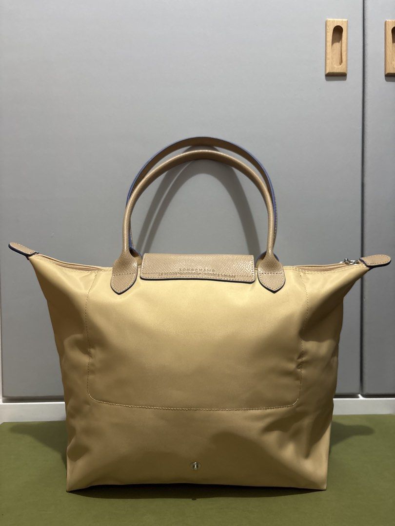 Longchamp Le Pliage Tote Bag Beige (Category: Luxury Bags & Wallets) located in Subic. Submitted by dear.jeveaph (Listing ID 1459782427, Image 2). Description: - Classic Longchamp tote bag - Color: Beige nylon with tan leather trim and handles - Iconic horse logo detail - Closure: Zipper with snap button flap - Perfect for everyday use, work, or travel - Spacious interior - No issue - Will pass as brand new - Still in pristine condition! .