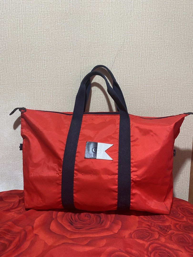 Longchamp Red Nylon Duffel Bag (Category: Luxury Bags & Wallets) located in Manila. Submitted by cdb_22 (Listing ID 1459818823, Image 1). Description: - Authentic Red Longchamp Duffel Bag - Navy Blue Handles and Trim - Classic Longchamp Logo Button - Ideal for Weekend Trips or Gym Use - Spacious Interior - Easy to Carry Design.