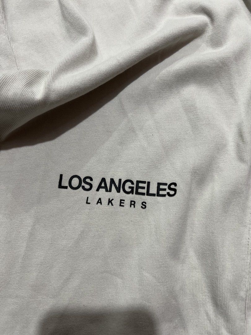Los Angeles Lakers Snap Button Track Pants (Category: Joggers) located in Manila. Submitted by okeanos (Listing ID 1459759842, Image 2). Description: - Cream colored track pants - Los Angeles Lakers branding - Snap buttons down the sides for adjustable fit and style - NBA logo and embroidered logo on the front - Elastic waistband with drawstring - Cuffed ankles - Great for casual wear or game day.