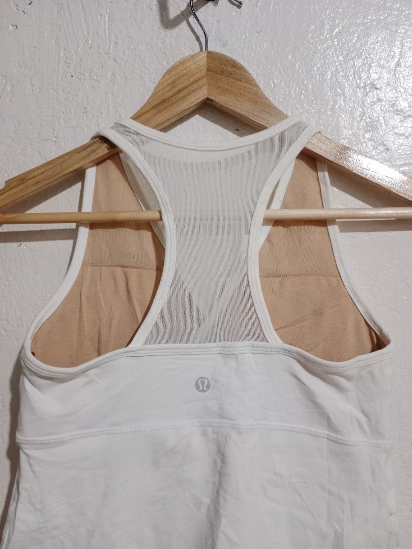 Lululemon White Tank Top with Built-in Bra (Category: Activewear) located in Toledo. Submitted by zealzionta54269 (Listing ID 1459745810, Image 2). Description: - White Lululemon tank top - Built-in bra with mesh back detail - Racerback style - Ideal for workouts and casual wear - Comfortable and breathable fabric -width 14-15 -length 21.