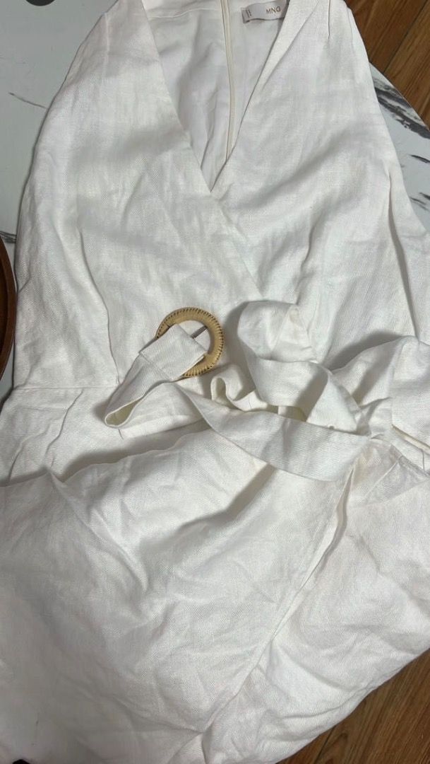 Mango Belt Linen Dress Off White (Category: Dresses) located in Pasig City. Submitted by sartorialclutter (Listing ID 1456399996, Image 3). Description: - Off-white linen midi dress - V-neckline - Sleeveless - Includes a belt with a circular buckle detail - Ideal for summer occasions - Versatile for dressing up or down.