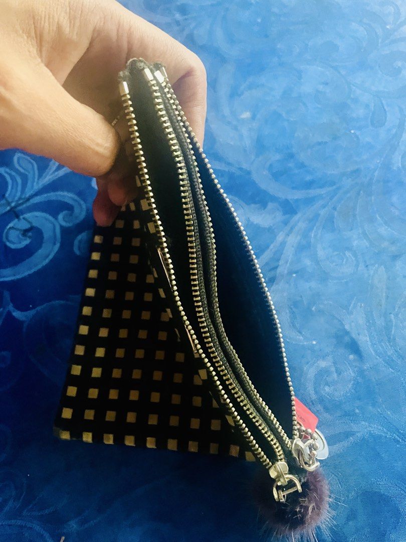 Marc by Marc Jacobs Black White Checkered Pouch (Category: Luxury Bags & Wallets) located in Caloocan City. Submitted by hardestea2026 (Listing ID 1459759062, Image 3). Description: - Cute Marc by Marc Jacobs pouch - Black with white checkered pattern - Small pompom charm attached - Zipper closure - Multiple compartments inside - Ideal for organizing makeup or small essentials.