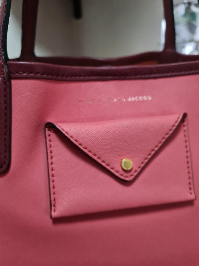 Marc by Marc Jacobs Pink Tote Bag with Pouch (Category: Luxury Bags & Wallets) located in Manila. Submitted by sevyaleinad (Listing ID 1459704896, Image 3). Description: - Authentic Marc by Marc Jacobs pink tote bag - Features stylish burgundy trim and handles - Comes with a matching small pouch for organizing essentials - Spacious interior, ideal for everyday use - Perfect for carrying your daily necessities in style.