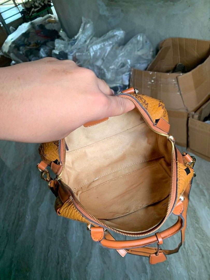 MCM Monogram Boston Bag (Category: Luxury Bags & Wallets) located in Vigan. Submitted by wiggy_10 (Listing ID 1459810700, Image 3). Description: - Classic MCM monogram Boston bag - Color: Tan with brown leather trim - Hardware: Gold details - Closure: Zipper - Interior: Suede-like lining - Includes: Detachable shoulder strap - Ideal for: Everyday use.