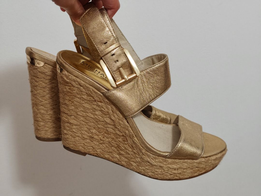 Michael Kors Gold Espadrille Wedge Sandals (Category: Wedges) located in Caloocan City. Submitted by kymmy_barbie (Listing ID 1459782921, Image 2). Description: - Brand: Michael Kors - Style: Espadrille Wedge Sandals - Color: Metallic Gold - Features: Adjustable buckle strap - Wedge: Jute rope wrapped - Versatility: Perfect for dressing up or down.