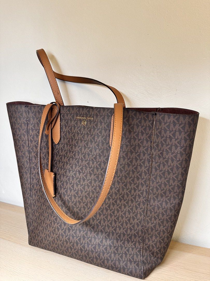 Michael Kors Monogram Tote Bag (Category: Luxury Bags & Wallets) located in Baguio. Submitted by judyannlacaden (Listing ID 1459886540, Image 3). Description: - Classic Michael Kors tote bag - Brown monogram print with tan leather accents - Spacious interior, ideal for everyday use - Prominent logo on the front - Includes a matching leather tag - Comfortable carrying handles.