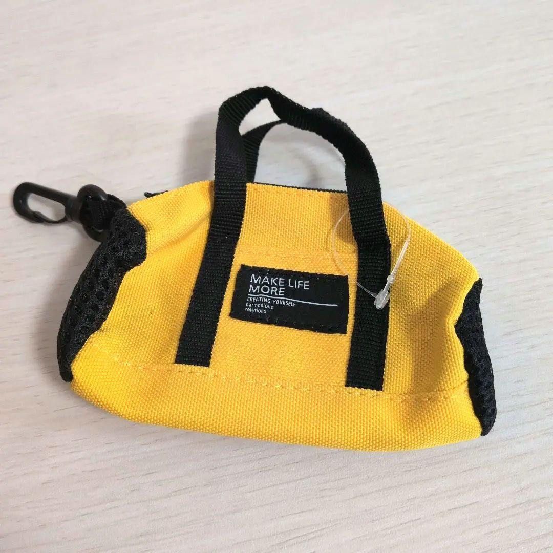 Mini Boston bag with key ring (Category: Wallets & Card holders) located in Manila. Submitted by wondermoma.ph (Listing ID 1459862776, Image 2). Description: Material: Body: Polyester Product Size: Body Size: W11 x D5 x H12cm, Total Length: 17cm, Quantity: 1 piece Colors: Black, Yellow For storing small items.