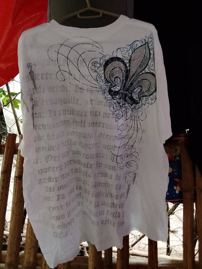 MMA elite (Category: Activewear) located in Pili. Submitted by alexsanandres412 (Listing ID 1459769031, Image 2). Description: - Classic white t-shirt - Large front graphic: Skull with wings and ornate details - Back design: Fleur-de-lis with text - Ideal for casual wear - Check photos for complete design.