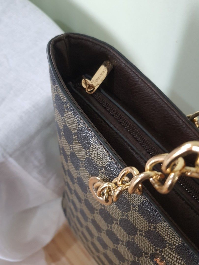 Montana West Monogram Chain Tote Bag (Category: Luxury Bags & Wallets) located in Quezon City. Submitted by pinksgate31 (Listing ID 1459727182, Image 3). Description: - Montana West monogram tote bag - Color: Brown and tan - Features elegant gold chain detail - Secure top zipper closure - Interior with multiple compartments and zippered pockets for organization - Versatile: Ideal for everyday use or a night out Used twice only..