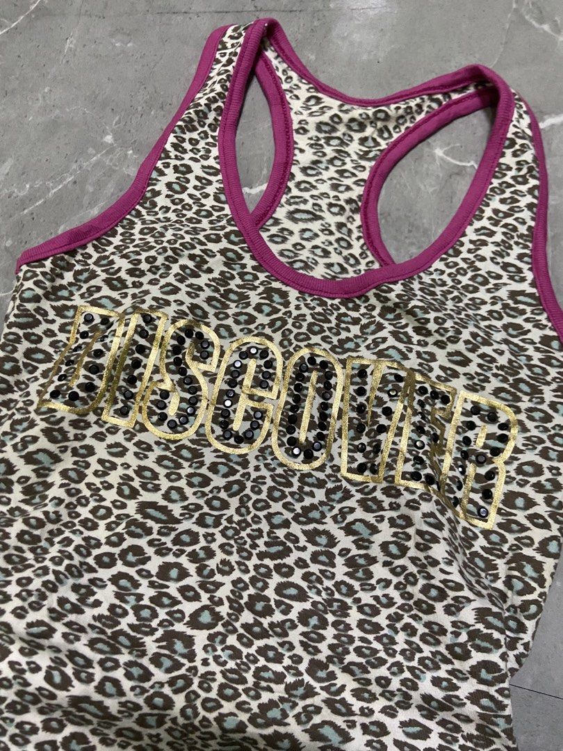 Moschino Leopard Print Tank Top with Sequins (Category: Sleeveless) located in Cebu City. Submitted by trueforest_k (Listing ID 1459691396, Image 2). Description: - Moschino leopard print tank top - Features gold sequins spelling out the brand name - Racerback style with purple trim - Fun and eye-catching design - Ideal for casual wear or workouts.