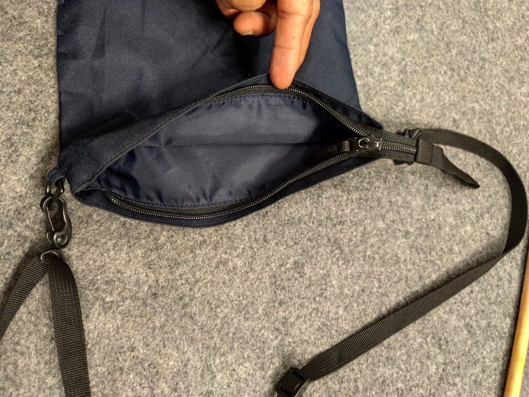 MUJI Navy Blue Crossbody Bag (Category: Sling Bags) located in Cordova. Submitted by bsb.streetluxvintage.clothing (Listing ID 1459783085, Image 2). Description: - Navy blue MUJI crossbody bag - Made in Vietnam - Main zippered compartment - Adjustable strap with buckle closure - Simple and functional design - Ideal for everyday use.