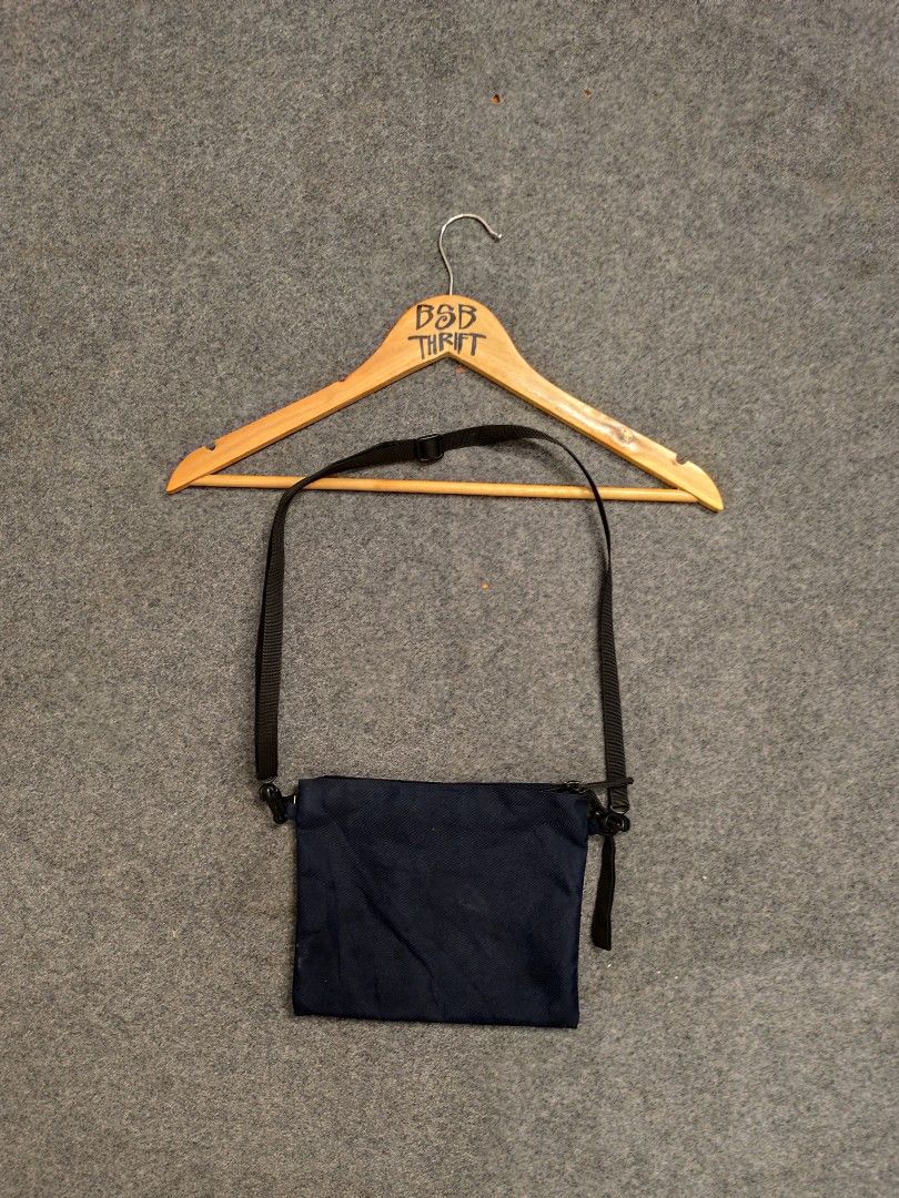 MUJI Navy Blue Crossbody Bag (Category: Sling Bags) located in Cordova. Submitted by bsb.streetluxvintage.clothing (Listing ID 1459783085, Image 1). Description: - Navy blue MUJI crossbody bag - Made in Vietnam - Main zippered compartment - Adjustable strap with buckle closure - Simple and functional design - Ideal for everyday use.
