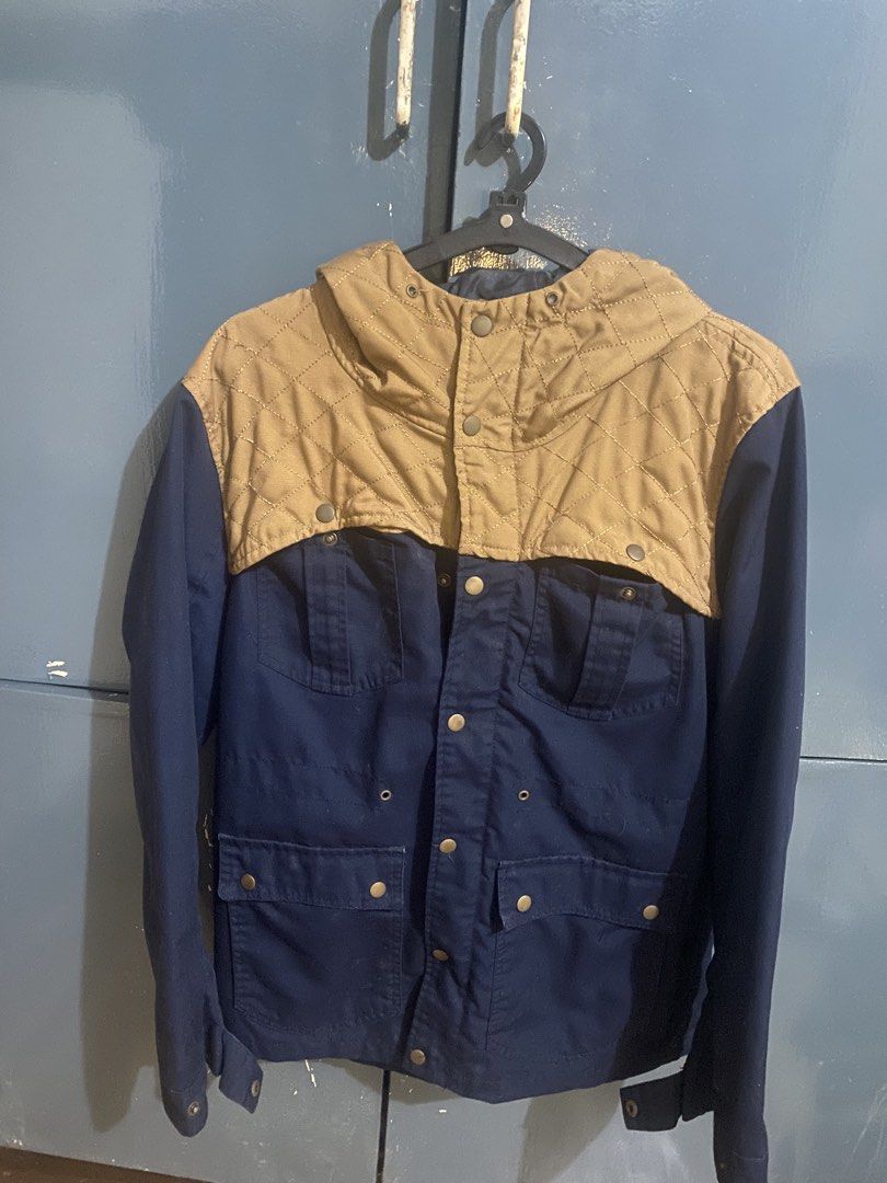 Quilted Hooded Jacket || packable jacket || workwear jacket (Category: Coats, Jackets and Outerwear) located in Manila. Submitted by alvarex (Listing ID 1459874279, Image 1). Description: - Stylish navy blue jacket - Tan quilted hood and upper chest panel - Button-up front closure - Multiple functional pockets - Adjustable drawstring at the waist for a custom fit - Ideal for cooler weather and a great look.