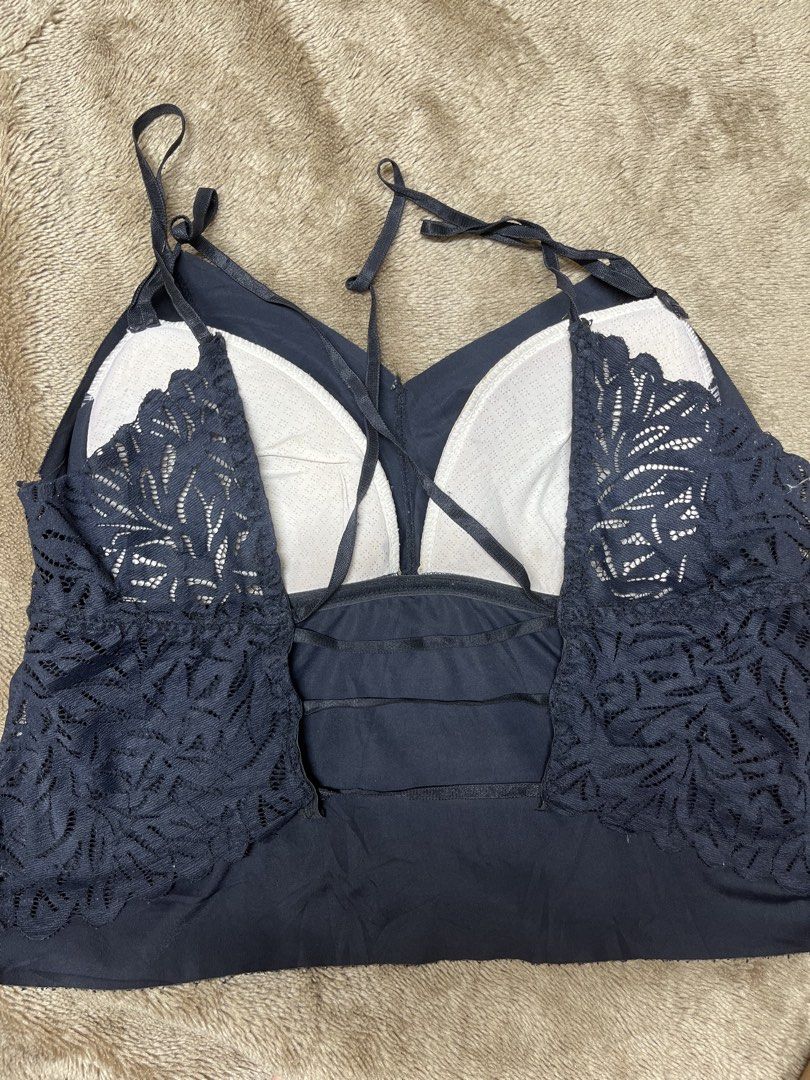 Black Lace Trimmed Cami Tank Top (Category: Sleeveless) located in Cavite. Submitted by bellewii (Listing ID 1459847572, Image 2). Description: - Navy blue cami tank top - Delicate lace trim on sides and back - Stylish criss-cross strap detail on the back - Built-in bra cups for added support - Versatile for layering or wearing as a standalone piece.