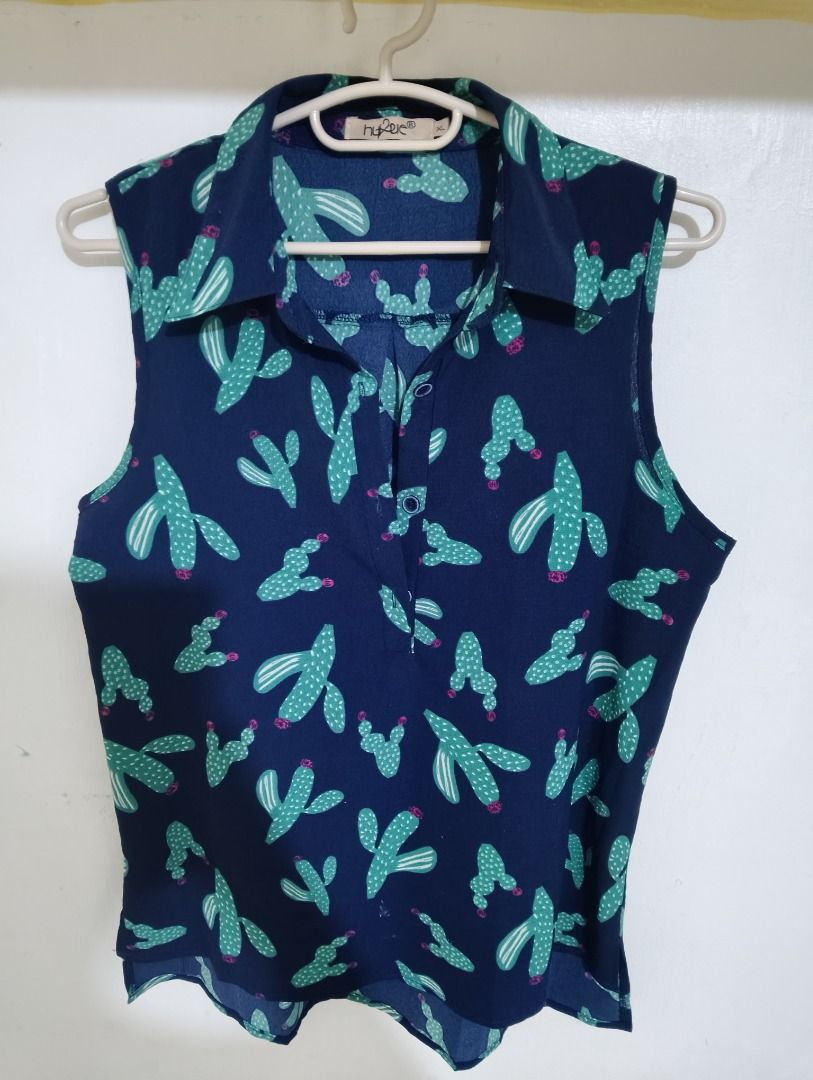 Navy Blue Sleeveless Top with Cactus Print (Category: Sleeveless) located in General Santos City (Dadiangas). Submitted by rjb21 (Listing ID 1459739305, Image 1). Description: - Navy blue sleeveless top - Adorable all-over cactus print in green and pink - Stylish collared neckline with button details - Perfect for a casual and fun look - Great for staying cool in warmer weather.