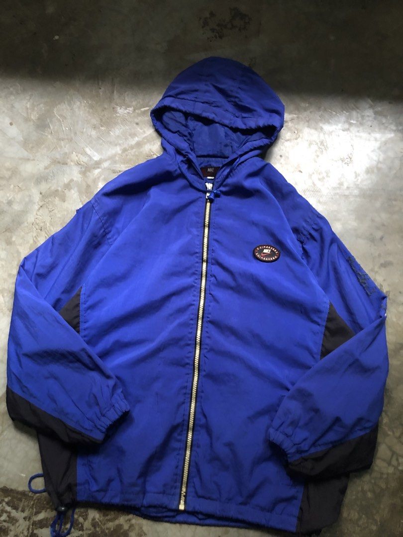 Nike Blue Black Hooded Windbreaker Jacket (Category: Coats, Jackets and Outerwear) located in San Pablo. Submitted by jilescalla (Listing ID 1459755734, Image 2). Description: - Blue and black Nike windbreaker jacket - Hooded with full zip closure - Drawstring at the hem for adjustable fit - Small Nike patch detail on the chest - Ideal for casual outings or sports activities.
