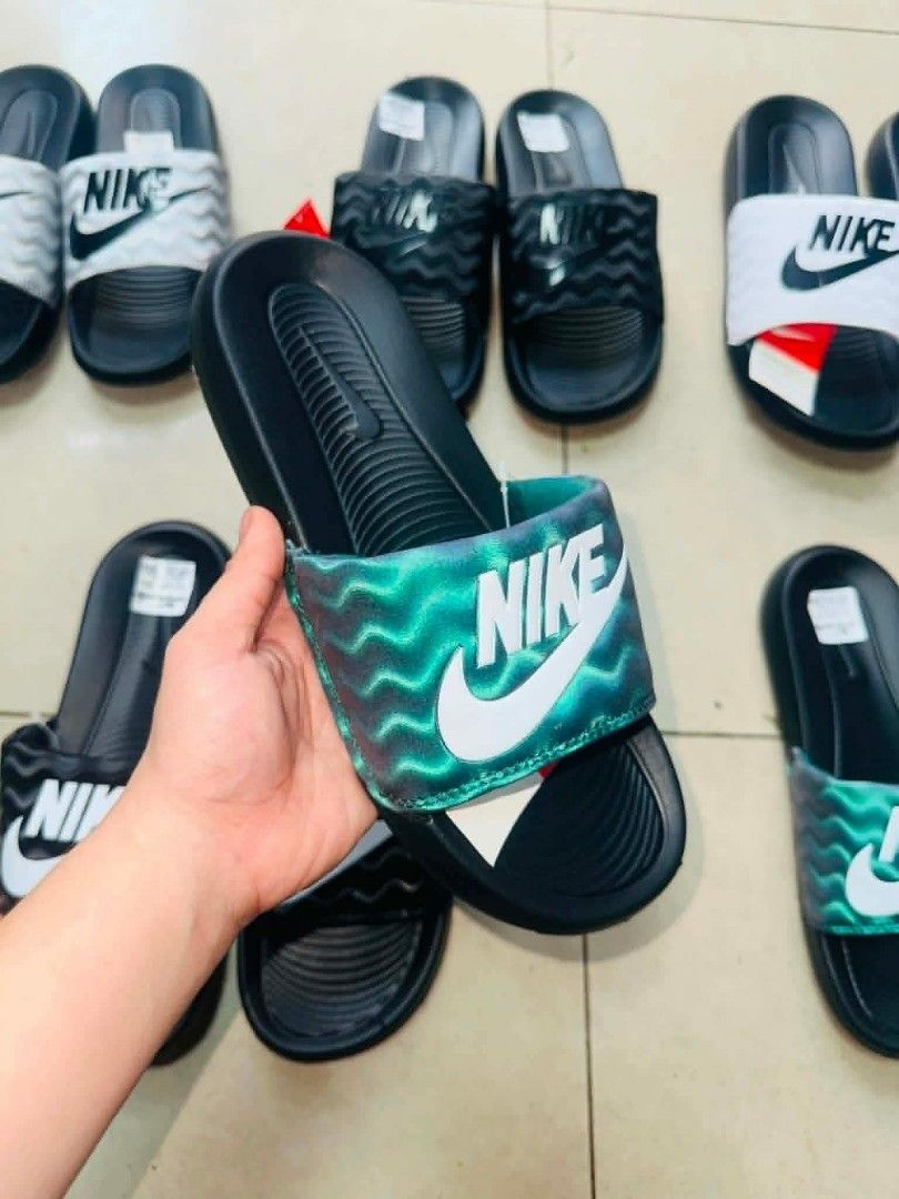 Nike Slides - Various Colors Available (Category: Slippers & Slides) located in Manila. Submitted by ashibambum_05 (Listing ID 1459692504, Image 1). Description: - Comfortable Nike slides for everyday wear. - Available in white, black, green, and silver. - Perfect for lounging or quick errands. - Easy to slip on and off..