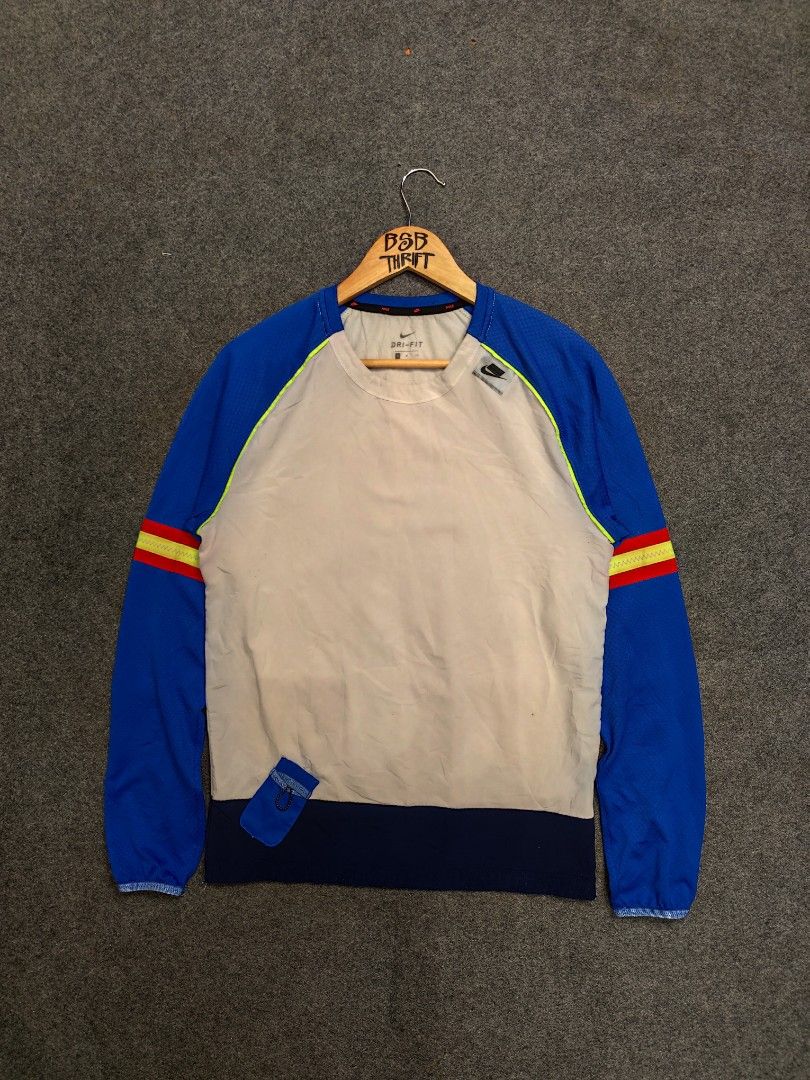 Nike Wild Run Longsleeve Sweatshirt (Category: Activewear) located in Cordova. Submitted by bsb.streetluxvintage.clothing (Listing ID 1459794775, Image 1). Description: - Nike Dri-FIT sweatshirt - Blue long sleeves with yellow and red stripe detail - Cream body - Small zippered pocket on the front - Ideal for workouts or casual wear - Made in Vietnam.