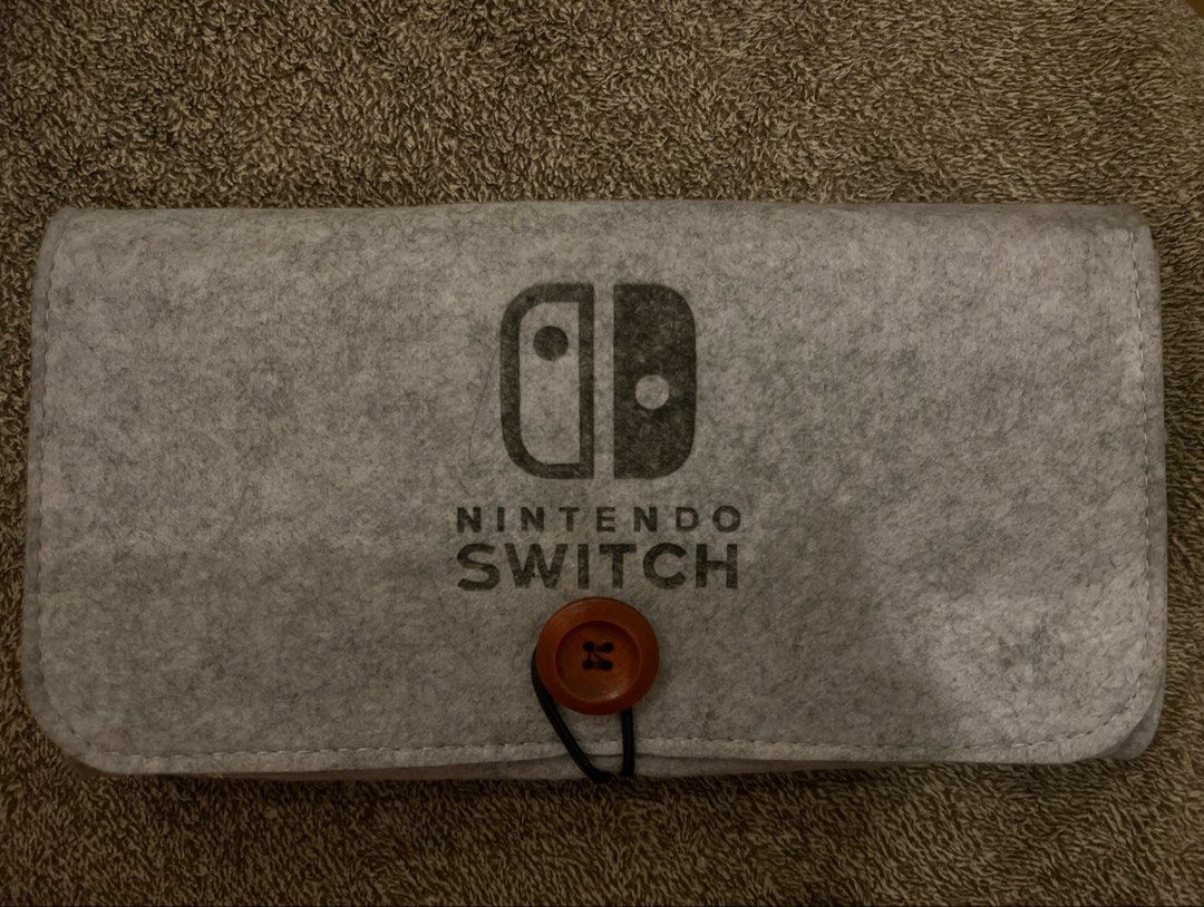 Nintendo Switch Felt Travel Case (Category: Cases & Covers) located in Taguig. Submitted by bugsilog (Listing ID 1459832063, Image 1). Description: 🗡️ For more pictures and details, please kindly message me! - Details: Comes with two big compartments and 5 Cartridge Slots for your games! - Condition: Kept in storage with care, just like new. - RFS: Decluttering.
