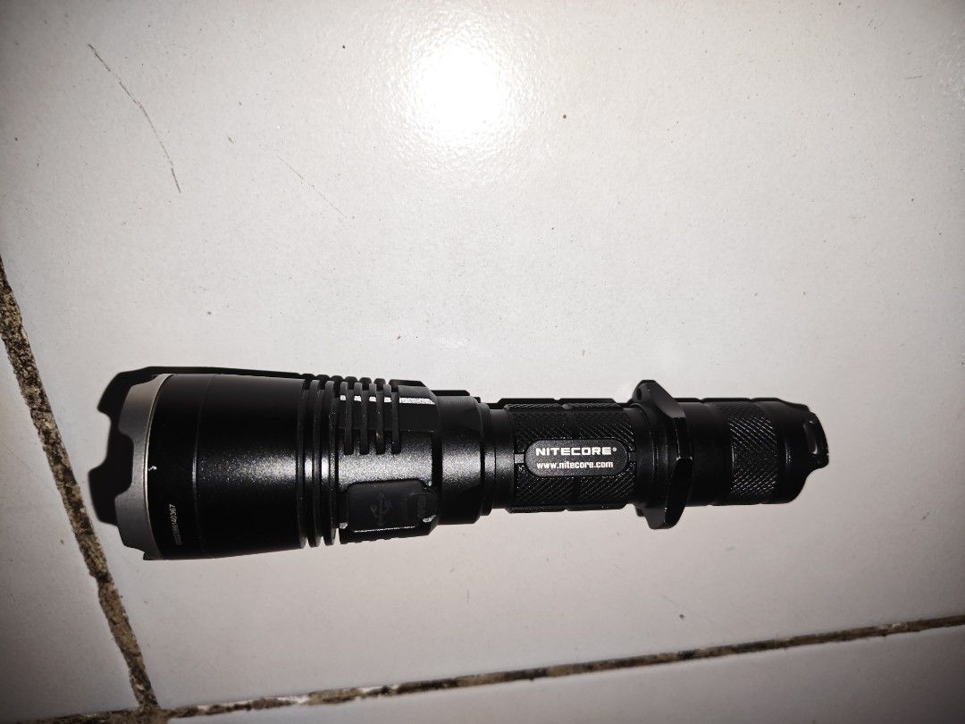Nitecore MH27 Flashlight (Category: Lighting) located in Pasig City. Submitted by ethan202 (Listing ID 1459812445, Image 2). Description: for sale only unit only and one battery for testing no defects, good condition. reliable brand flashlight. barely used - Nitecore MH27 flashlight - Durable black aluminum body - Features a tactical ring for enhanced grip - Convenient side button for power and mode adjustments - Compact yet powerful design - Per