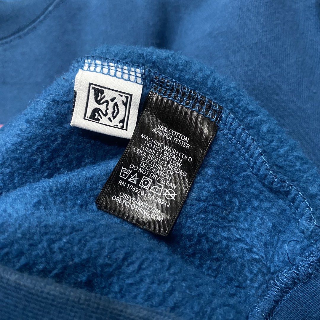 OBEY Blue Graphic Sweatshirt Size M (Category: Coats, Jackets and Outerwear) located in Naga. Submitted by ejdurante17 (Listing ID 1459745941, Image 2). Description: - Brand: OBEY - Color: Blue - Size: Medium (M) on tag but dimension is (L: 28” x W: 23”) can fit up to Large - Design: Features a unique graphic print of a hand holding a flower on the front. - Material: Comfortable cotton and polyester blend. - Style: Ideal for casual everyday wear.