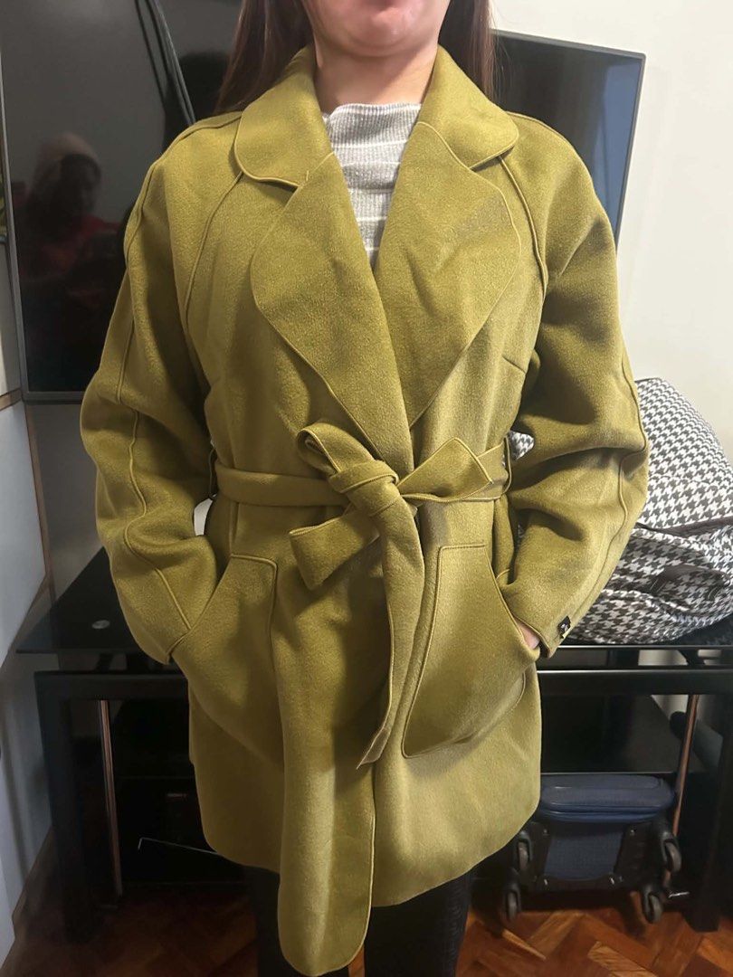 Olive Green Belted Lapel Coat (Category: Coats, Jackets and Outerwear) located in Makati City. Submitted by kriscelity (Listing ID 1459799462, Image 3). Description: Vietnam-Bought Olive Green Trench Coat - Worn Once | P1,200 Worn once only, excellent/like-new condition *I Bought in Vietnam during my trip in March 2025 Elegant olive/mustard green color * Belted waist with structured lapel and pockets No noticeable flaws; very well maintained Sell