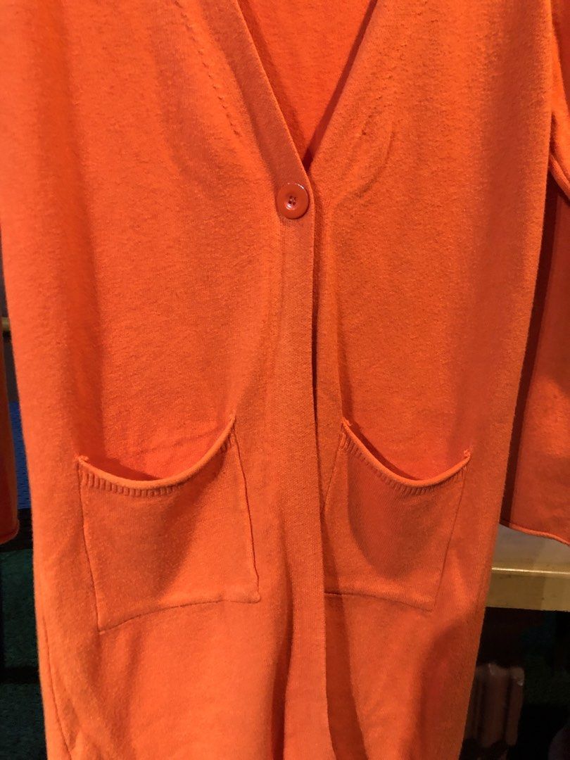 Orange Longline Cardigan with Pockets (Category: Coats, Jackets and Outerwear) located in Cauayan City . Submitted by wholly.craaaft (Listing ID 1459799003, Image 2). Description: - Orange longline cardigan - V-neck with single button closure - Two front pockets - Long sleeves - Ideal for layering on cooler days - Versatile styling with jeans or leggings.