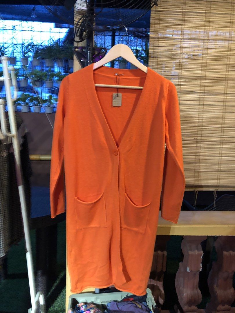 Orange Longline Cardigan with Pockets (Category: Coats, Jackets and Outerwear) located in Cauayan City . Submitted by wholly.craaaft (Listing ID 1459799003, Image 1). Description: - Orange longline cardigan - V-neck with single button closure - Two front pockets - Long sleeves - Ideal for layering on cooler days - Versatile styling with jeans or leggings.