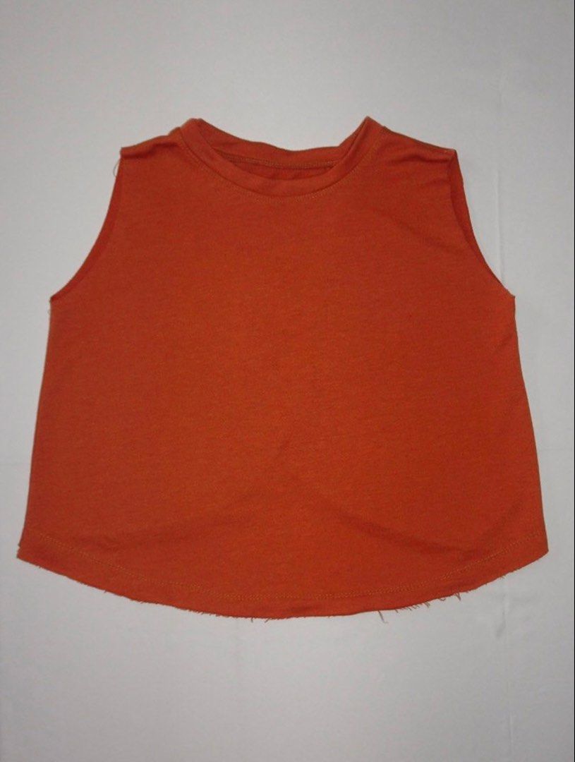 Orange Sleeveless Cropped Top (Category: Sleeveless) located in Manila. Submitted by kim.declutterss (Listing ID 1459776793, Image 1). Description: - Size: Fits XS-medium - Sleeveless orange crop top - Raw hem finish - Classic crew neck - Overlap layer on back - Ideal for layering or standalone wear - Effortlessly pairs with high-waisted pants or skirts - Issue: loose stitching on armholes and hem.