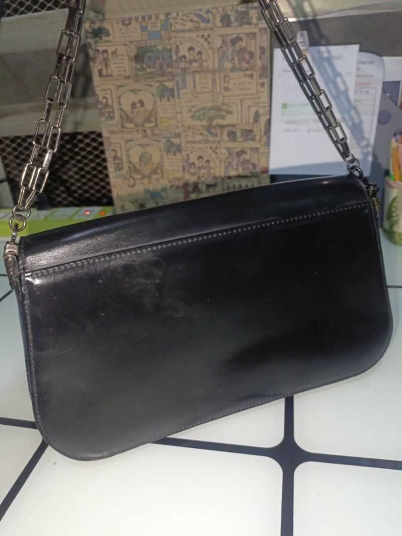 Paco Rabbane Sling Box (Category: Luxury Bags & Wallets) located in San Pedro. Submitted by elevens_online_thrift_shop (Listing ID 1459752726, Image 3). Description: * **Brand**: Paco Rabanne (Paris) * **Design & Features**: A vintage black leather shoulder/flap bag featuring a structured silhouette, dark gunmetal/silver-tone chain strap, magnetic snap closures, a textile-lined interior with zipper pockets, and a prominent square metal logo plate