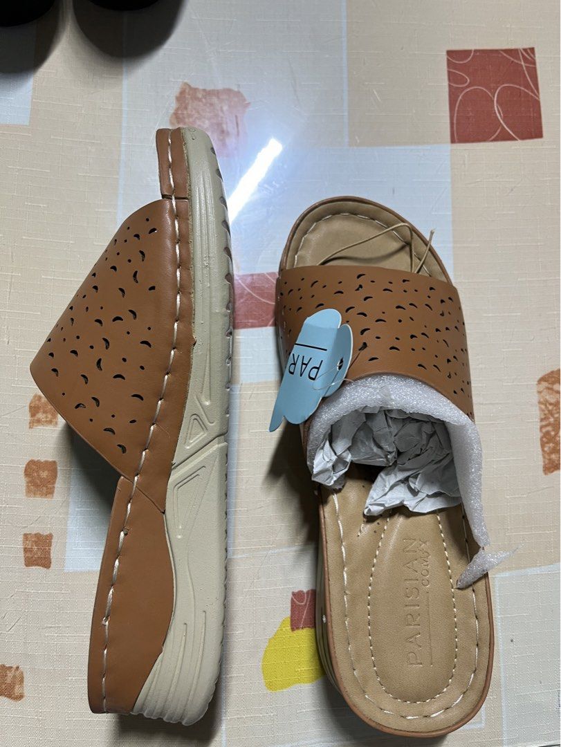 PARISIAN COMFY Brown Perforated Slides Sandals (Category: Flats & Sandals) located in Manila. Submitted by graceeeeee_ (Listing ID 1459742902, Image 2). Description: - Brand: PARISIAN COMFY - Color: Brown - Style: Open-toe slides - Design: Perforated strap across the foot - Sole: Comfortable wedge sole - Occasion: Perfect for casual wear - Condition: Comes with original packaging.