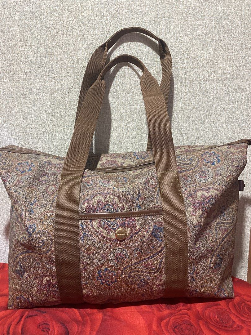 Pierre Cardin Paisley Duffle Bag (Category: Luxury Bags & Wallets) located in Manila. Submitted by cdb_22 (Listing ID 1459818642, Image 1). Description: - Classic paisley print duffle bag by Pierre Cardin. - Features brown canvas straps and elegant leather trim. - Convenient front pocket with a secure gold button closure. - Spacious interior, ideal for weekend getaways or gym sessions. - Secure zipper closure on top. - Perfect size for a weekend 