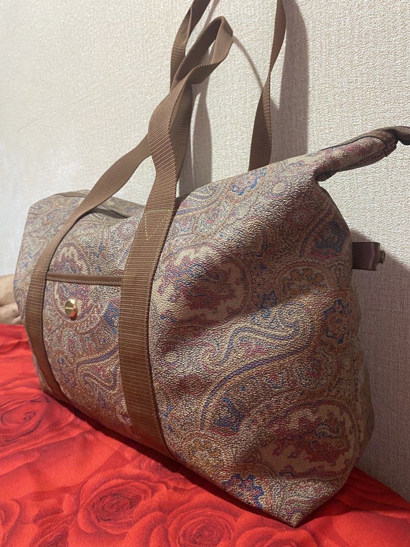 Pierre Cardin Paisley Duffle Bag (Category: Luxury Bags & Wallets) located in Manila. Submitted by cdb_22 (Listing ID 1459818642, Image 3). Description: - Classic paisley print duffle bag by Pierre Cardin. - Features brown canvas straps and elegant leather trim. - Convenient front pocket with a secure gold button closure. - Spacious interior, ideal for weekend getaways or gym sessions. - Secure zipper closure on top. - Perfect size for a weekend 
