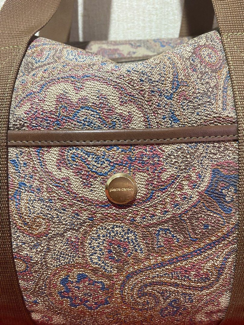 Pierre Cardin Paisley Duffle Bag (Category: Luxury Bags & Wallets) located in Manila. Submitted by cdb_22 (Listing ID 1459818642, Image 2). Description: - Classic paisley print duffle bag by Pierre Cardin. - Features brown canvas straps and elegant leather trim. - Convenient front pocket with a secure gold button closure. - Spacious interior, ideal for weekend getaways or gym sessions. - Secure zipper closure on top. - Perfect size for a weekend 