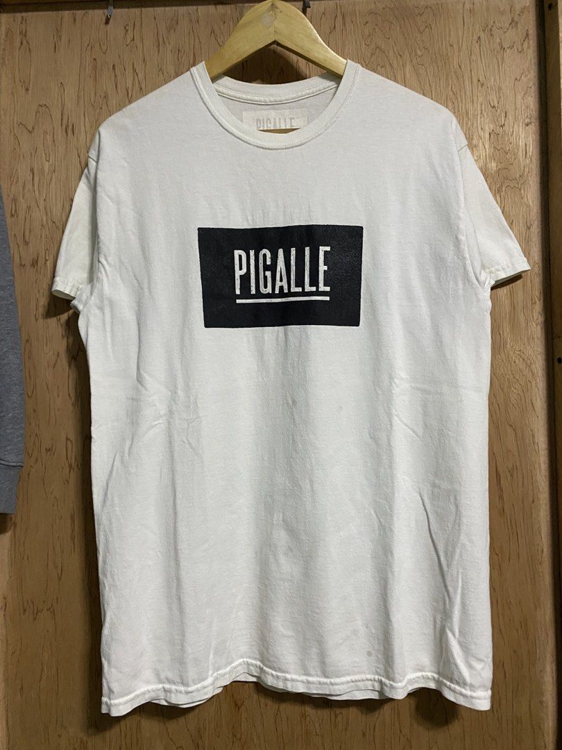 PIGALLE White T-shirt (Category: Tshirts & Polo Shirts ) located in Manila. Submitted by callejage69430 (Listing ID 1459772784, Image 1). Description: 20 width 28 length Need wash - Classic white PIGALLE t-shirt - Features the iconic PIGALLE logo in a black box on the front - Simple and timeless design - Ideal for casual everyday wear.