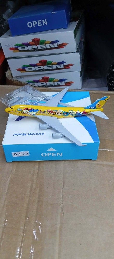 Pikachu 8747 ANA Aircraft Model (Category: Vehicle & Diecast Models) located in Manila. Submitted by iliasjen3082126 (Listing ID 1459814913, Image 1). Description: - Pikachu 8747 ANA Aircraft Model - Features various Pokemon characters printed on the yellow plane - Comes with its original box - Ideal for collectors and Pokemon enthusiasts - Box marked 'Aircraft Model' and 'OPEN'.