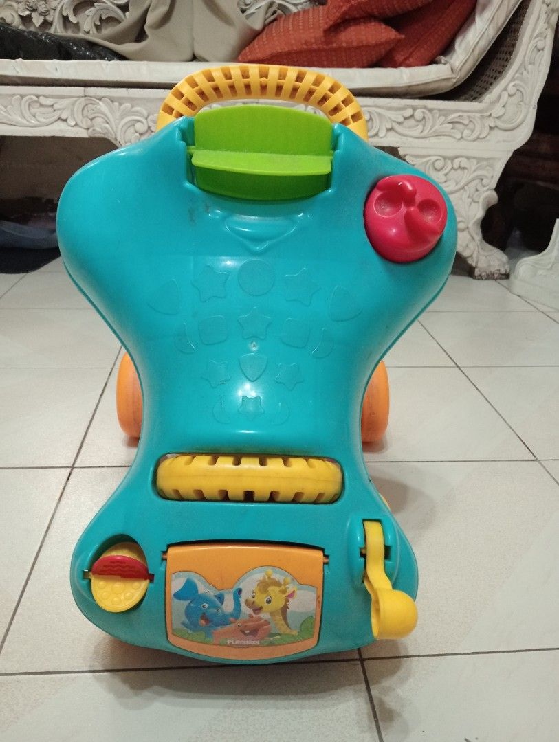 Playskool Baby Walker Ride-On Toy (Category: Infant Playtime) located in Makati City. Submitted by YSL80022 (Listing ID 1459765514, Image 3). Description: - Fun Playskool Walker and Ride-On Toy - Bright teal, yellow, and purple colors - Features cute animal graphics - Dual function: push handle for walking, seat for riding - Perfect for toddlers learning to walk or cruise - Shows some scuffs from normal use.