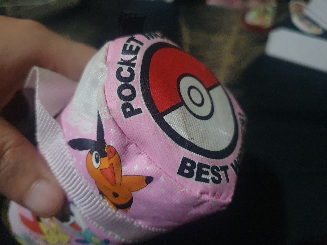 Pokemon "Pocket Monsters" mini Duffle Pouch Bag (Category: Purses & Pouches) located in Quezon City. Submitted by collectionneursonline88 (Listing ID 1459809843, Image 2). Description: - Adorable pink pouch featuring popular Pokemon characters: Pikachu, Snivy, Oshawott, Torchic, and Victini. - "Pocket Monsters" and "Best Wishes" text adds a nostalgic touch. - Features a secure zipper closure and two convenient handles. - Ideal for organizing and 