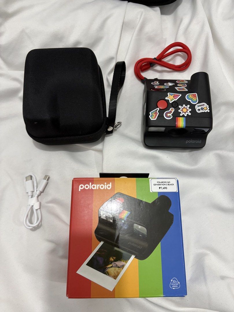 Polaroid Go Generation 3 Black Instant Camera with Case (Category: Cameras) located in Bustos. Submitted by bigbite08 (Listing ID 1459879106, Image 2). Description: - Black Polaroid Go Generation 3 instant camera - Comes with protective case - Includes charging cable - Features cute stickers on the camera - Original box included - Ideal for capturing memories instantly.