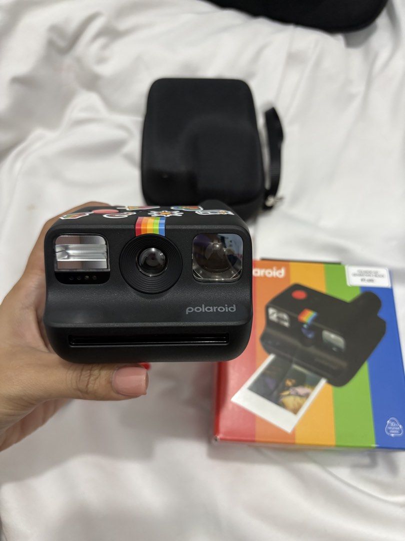 Polaroid Go Generation 3 Black Instant Camera with Case (Category: Cameras) located in Bustos. Submitted by bigbite08 (Listing ID 1459879106, Image 1). Description: - Black Polaroid Go Generation 3 instant camera - Comes with protective case - Includes charging cable - Features cute stickers on the camera - Original box included - Ideal for capturing memories instantly.
