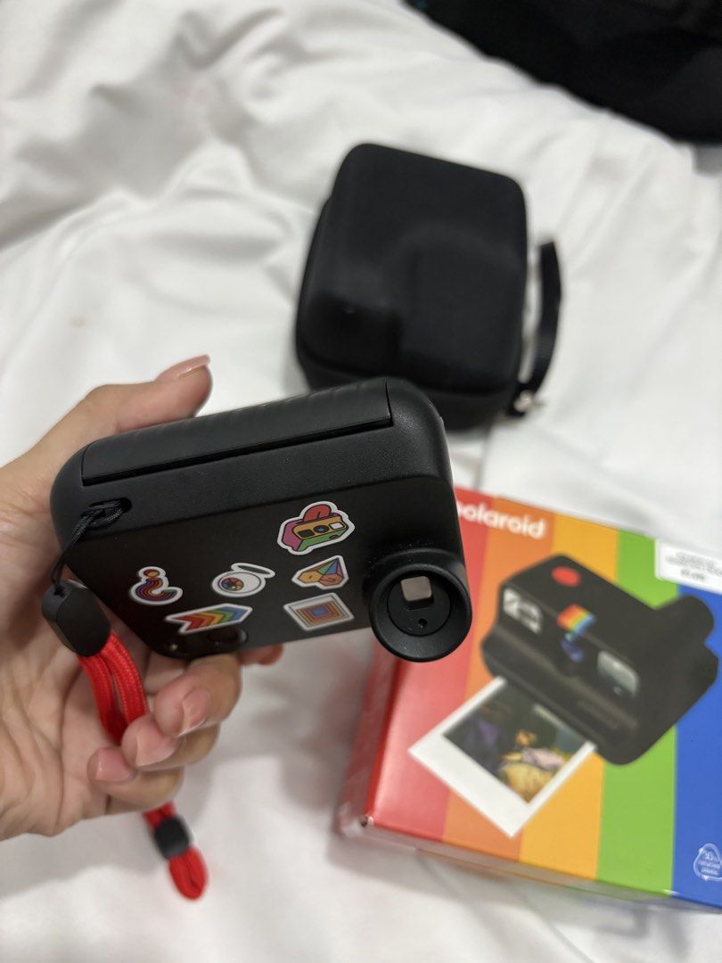 Polaroid Go Generation 3 Black Instant Camera with Case (Category: Cameras) located in Bustos. Submitted by bigbite08 (Listing ID 1459879106, Image 3). Description: - Black Polaroid Go Generation 3 instant camera - Comes with protective case - Includes charging cable - Features cute stickers on the camera - Original box included - Ideal for capturing memories instantly.