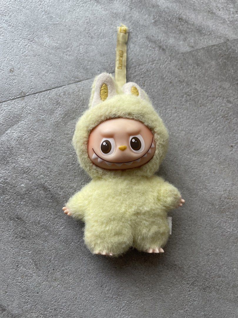 Pop Mart Kasing Labubu Plush Toy Keychain Yellow (Category: Plushies & Soft Toys) located in Midsayap. Submitted by archieaquino24 (Listing ID 1459717992, Image 1). Description: - Adorable yellow plush toy with cute bunny ears. - Features official Pop Mart and Kasing branding. - Small embroidered 'F' detail on the back. - Includes a convenient loop for hanging. - Ideal accessory for your bags, backpacks, or keys..