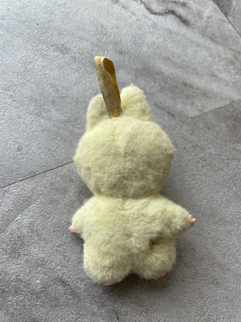 Pop Mart Kasing Labubu Plush Toy Keychain Yellow (Category: Plushies & Soft Toys) located in Midsayap. Submitted by archieaquino24 (Listing ID 1459717992, Image 2). Description: - Adorable yellow plush toy with cute bunny ears. - Features official Pop Mart and Kasing branding. - Small embroidered 'F' detail on the back. - Includes a convenient loop for hanging. - Ideal accessory for your bags, backpacks, or keys..
