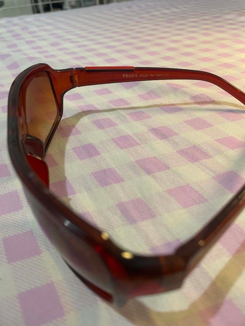 Vintage / Y2K Prada Sunglasses (Category: Sunglasses & Eyewear) located in Quezon City. Submitted by lovenzie (Listing ID 1459821162, Image 3). Description: LAST PRICE !! - authentic vintage prada sunglasses - y2k / mid-2000s - red frame with amber gradient lenses - made in Italy - selling as is! no box, etc 🛍️🍡 ౨ৎ⋆ ˚｡ mop: gcash shipping: lalamove / grab ( shipping fee will be shouldered by the buyer ) 🍰 loc: qc !.