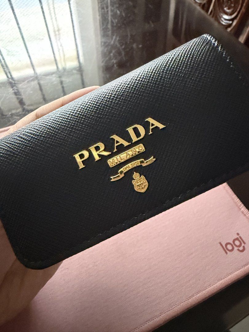 Prada Saffiano Leather Key Holder Black (Category: Luxury Bags & Wallets) located in Manila. Submitted by thraciecapule (Listing ID 1459726305, Image 1). Description: - Authentic Prada Key Holder - Material: Black Saffiano Leather - Hardware: Gold - Includes: Original Prada Box - Origin: Made in Italy - Benefit: Stylish and organized key keeping.