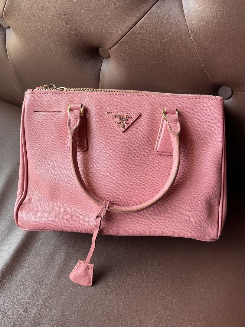 Prada Saffiano Leather Pink Top Handle Bag (Category: Luxury Bags & Wallets) located in Caloocan City. Submitted by trippsnthrifts (Listing ID 1459731810, Image 1). Description: - Authentic Prada bag in pink Saffiano leather - Made in Italy - Gold hardware details - Interior features Prada logo lining - Shows some signs of wear on handles and edges.